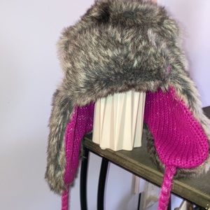 Reversible Faux fur Trapper hat style with pink lining and braided pom ties